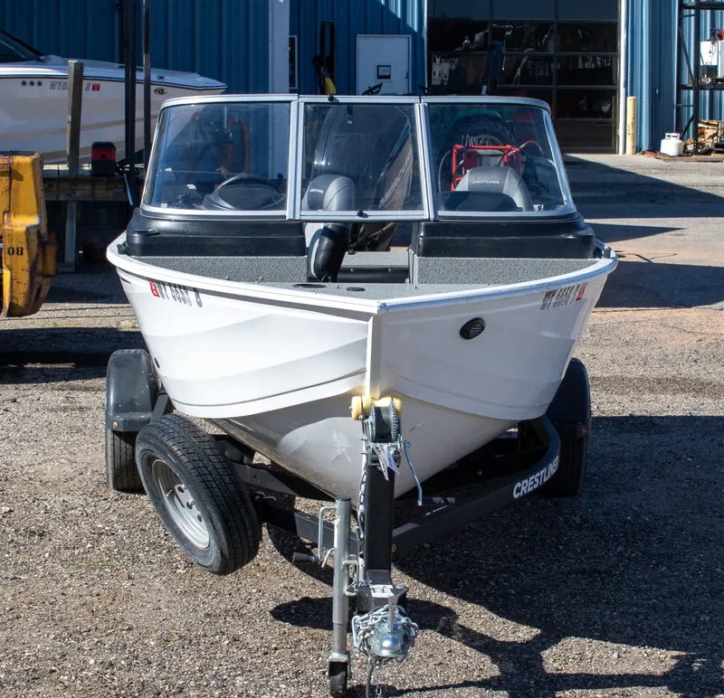 Slide: The Image of 2023 Crestliner 1600 Vision boat on trailer, parked outdoors. - 3
