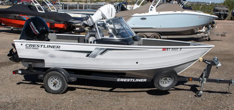 Slide: The Image of 2023 Crestliner 1600 Vision boat on trailer, parked outdoors. - 4