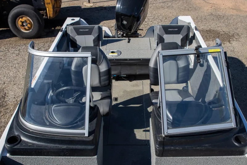 Slide: The Image of 2023 Crestliner 1600 Vision boat interior with dual consoles and seating. - 7
