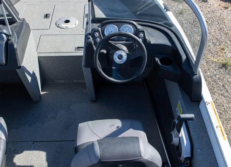 Slide: The Image of 2023 Crestliner 1600 Vision boat cockpit with steering wheel and controls. - 8