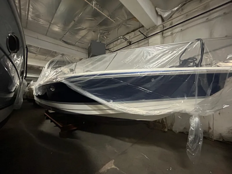 Slide: The Image of 2007 Formula 330 SS boat covered in plastic, stored indoors. - 1