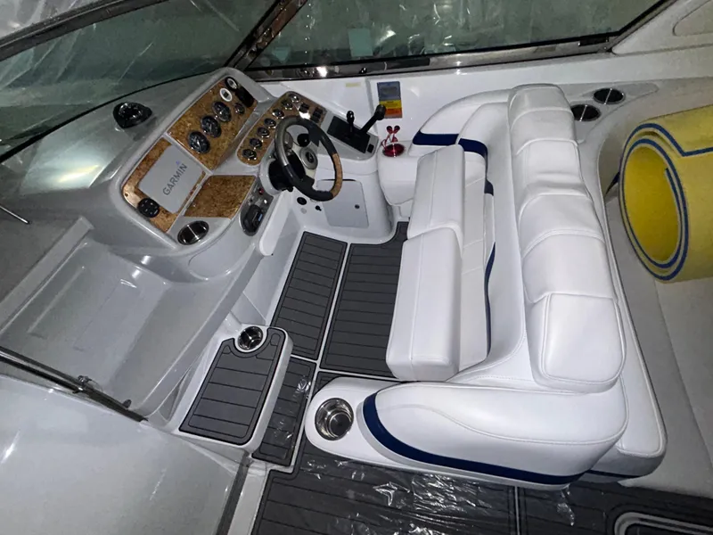 Slide: The Image of 2007 Formula 330 SS boat interior with white seating and control panel. - 4