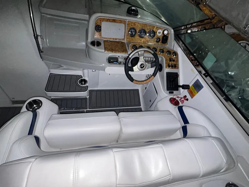 Slide: The Image of 2007 Formula 330 SS boat cockpit with white seating and detailed control panel. - 5