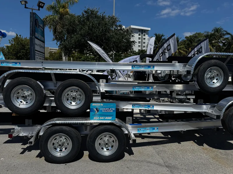 Slide: The Image of 2025 Trailer 17-30 model stacked at outdoor display with palm trees in background. - 1