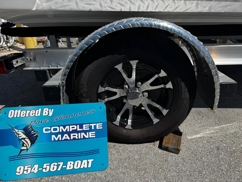 Slide: The Image of Trailer wheel with metallic fender, Complete Marine sign, contact number visible. - 10