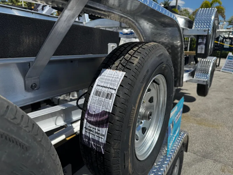 Slide: The Image of 2025 Trailer 17-30 with new tire, displayed outdoors on a sunny day. - 11