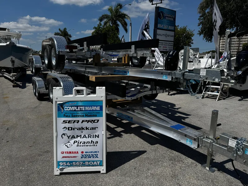 Slide: The Image of Trailer model 17-30, 2025, displayed at Complete Marine dealership with promotional signage. - 14
