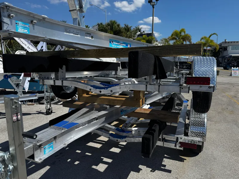 Slide: The Image of 2025 Trailer 17-30 with dual axles and metal frame in outdoor setting. - 5