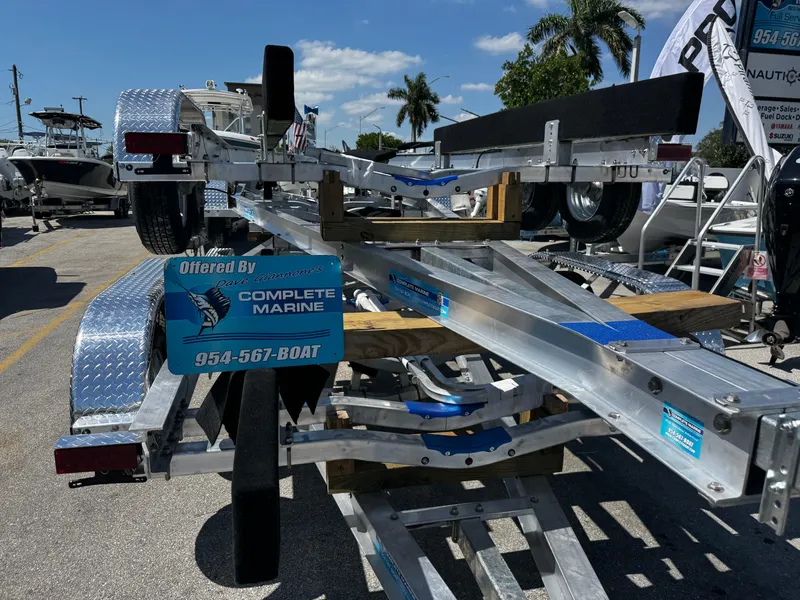 Slide: The Image of 2025 Trailer 17-30 by Complete Marine, displayed outdoors with palm trees in the background. - 6