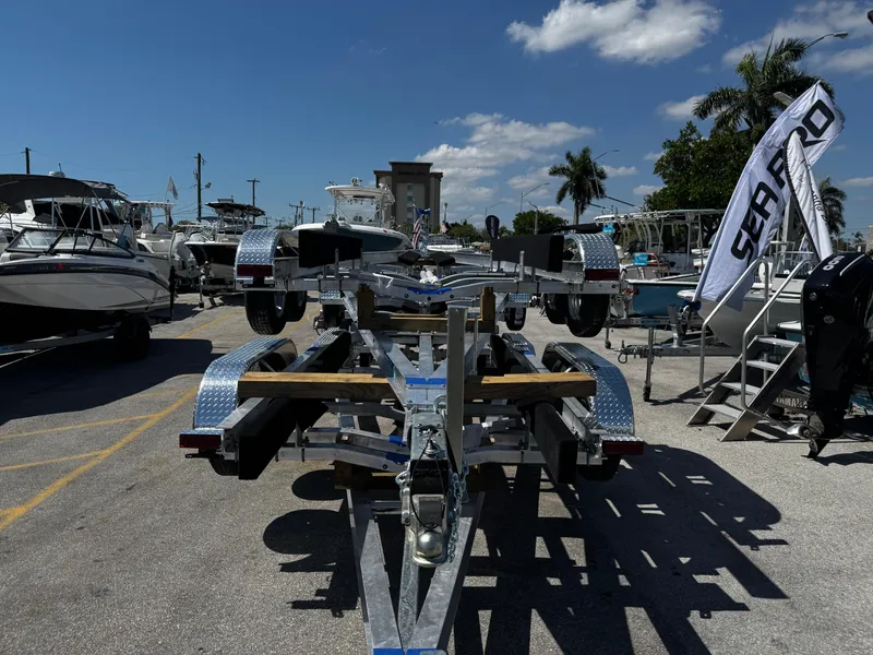 Slide: The Image of Boat trailer 17-30, 2025 model, displayed outdoors with boats and palm trees. - 8