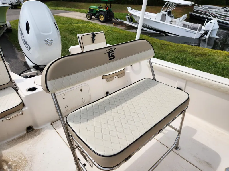 Slide: The Image of 2023 Carolina Skiff 21 LS boat seat with diamond-pattern upholstery and Suzuki outboard motor. - 11