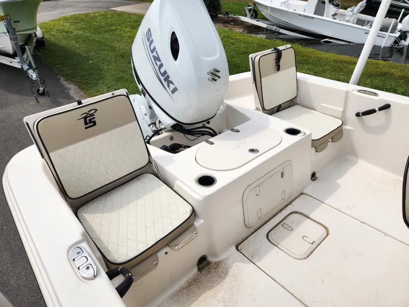Slide: The Image of 2023 Carolina Skiff 21 LS boat interior with Suzuki engine and cushioned seating. - 12