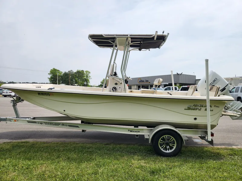 Slide: The Image of 2023 Carolina Skiff 21 LS boat on trailer, parked outdoors, side view. - 5