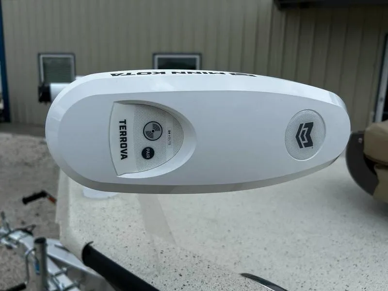 Slide: The Image of White Terrova trolling motor on 2025 Xpress H20 BAY boat, outdoor setting. - 10