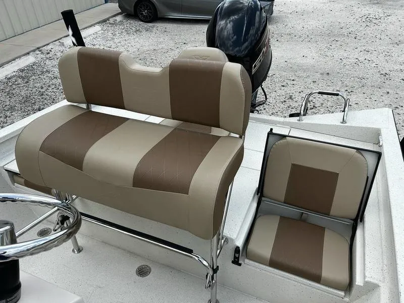 Slide: The Image of 2025 Xpress H20 BAY boat interior with beige and brown seating. - 11