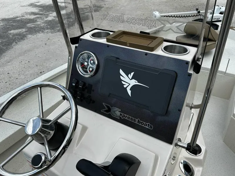 Slide: The Image of 2025 Xpress H20 BAY boat dashboard with steering wheel and control panel. - 5