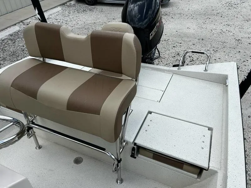 Slide: The Image of 2025 Xpress H20 BAY boat interior with cushioned seating and storage compartment. - 9