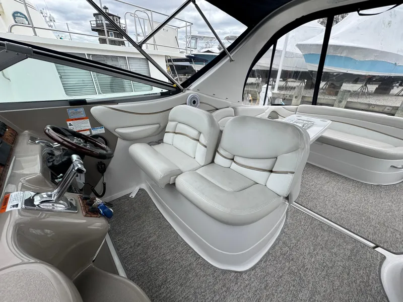 Slide: The Image of 2005 Larson 370 Cabrio boat interior with plush seating and modern helm controls. - 10