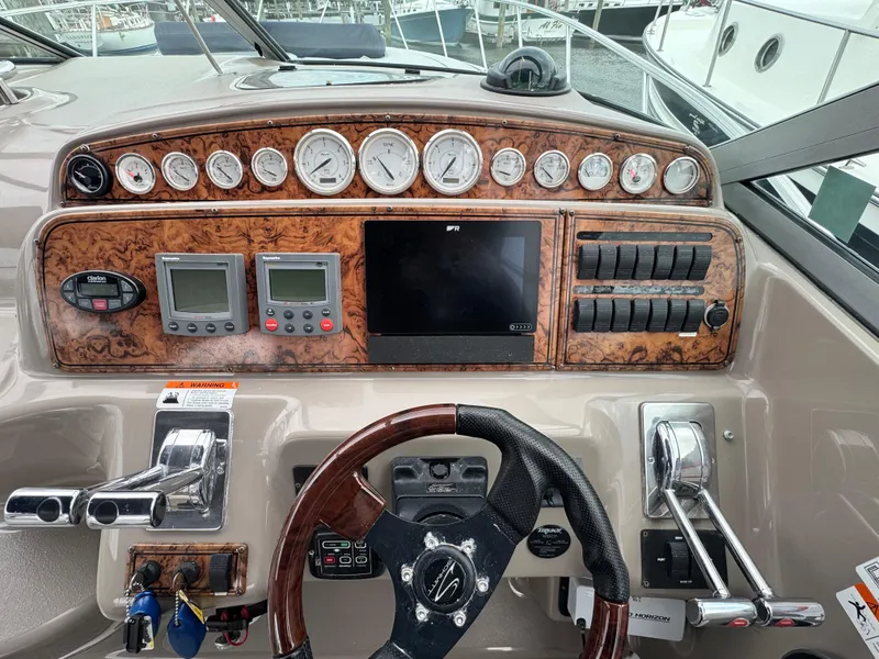 Slide: The Image of 2005 Larson 370 Cabrio dashboard with gauges, controls, and steering wheel. - 11