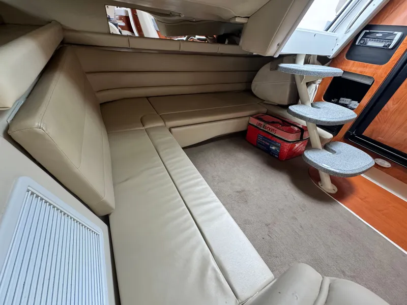 Slide: The Image of 2005 Larson 370 Cabrio interior with beige seating and compact staircase. - 16