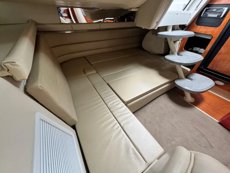 Slide: The Image of Interior of 2005 Larson 370 CABRIO boat with beige seating and compact design. - 17