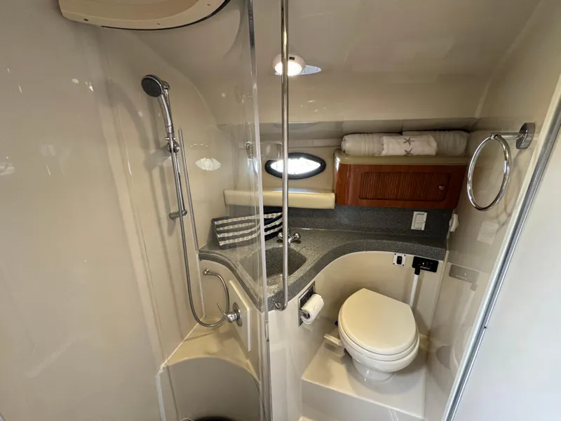 Slide: The Image of 2005 Larson 370 Cabrio bathroom with shower, toilet, sink, and storage cabinet. - 22