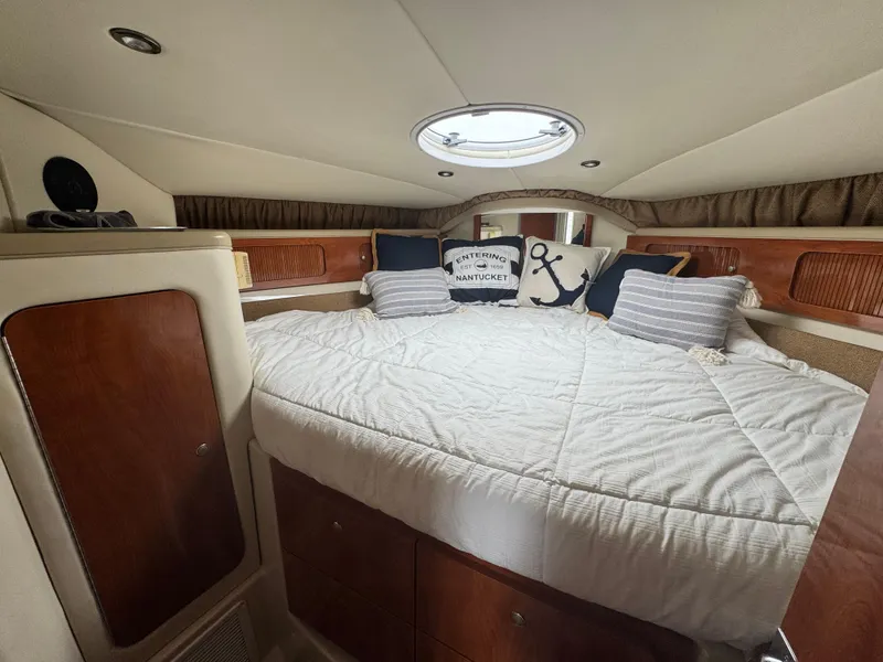 Slide: The Image of Cozy cabin interior of 2005 Larson 370 Cabrio with nautical-themed decor. - 24