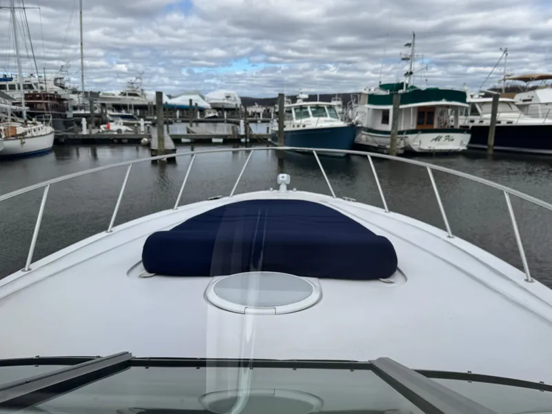 Slide: The Image of 2005 Larson 370 CABRIO yacht docked in a marina with overcast skies. - 25