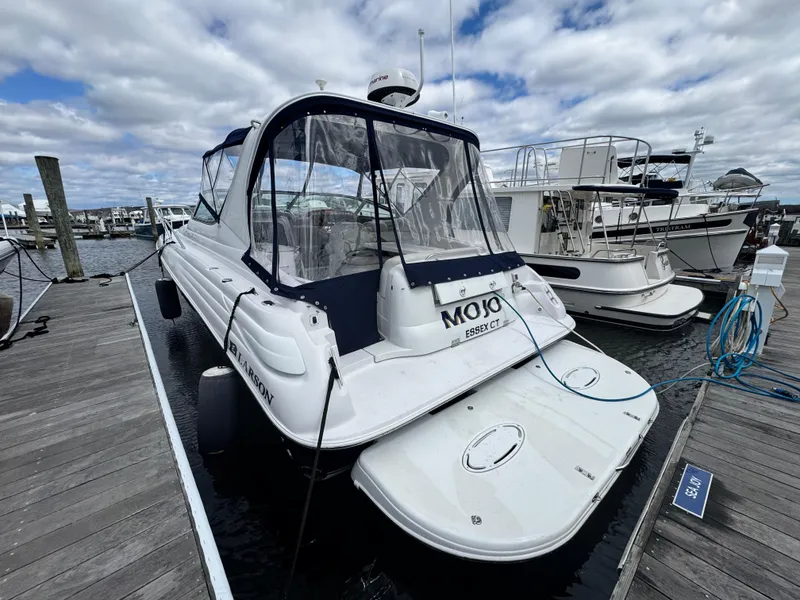 Slide: The Image of 2005 Larson 370 Cabrio boat docked at marina under cloudy sky. - 3