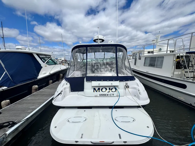 Slide: The Image of 2005 Larson 370 Cabrio boat docked at marina under cloudy sky. - 4