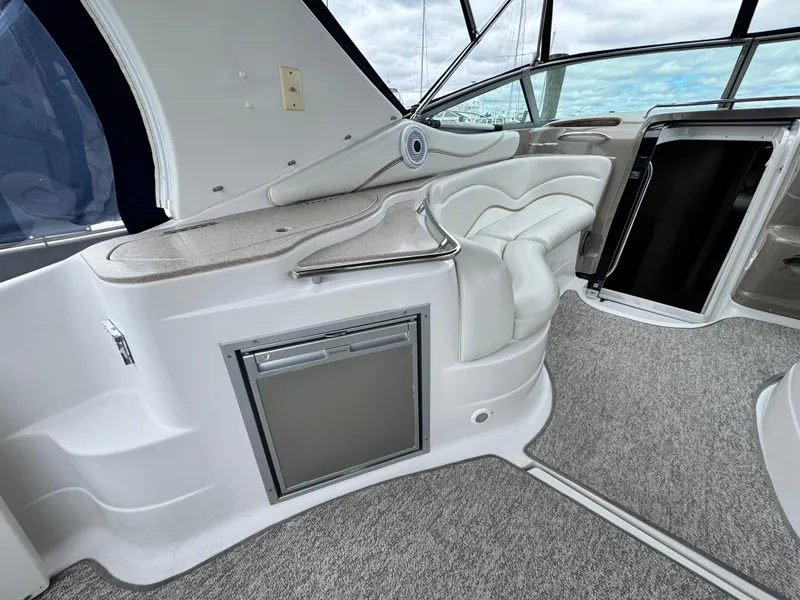 Slide: The Image of 2005 Larson 370 Cabrio interior with seating, mini fridge, and modern design elements. - 5