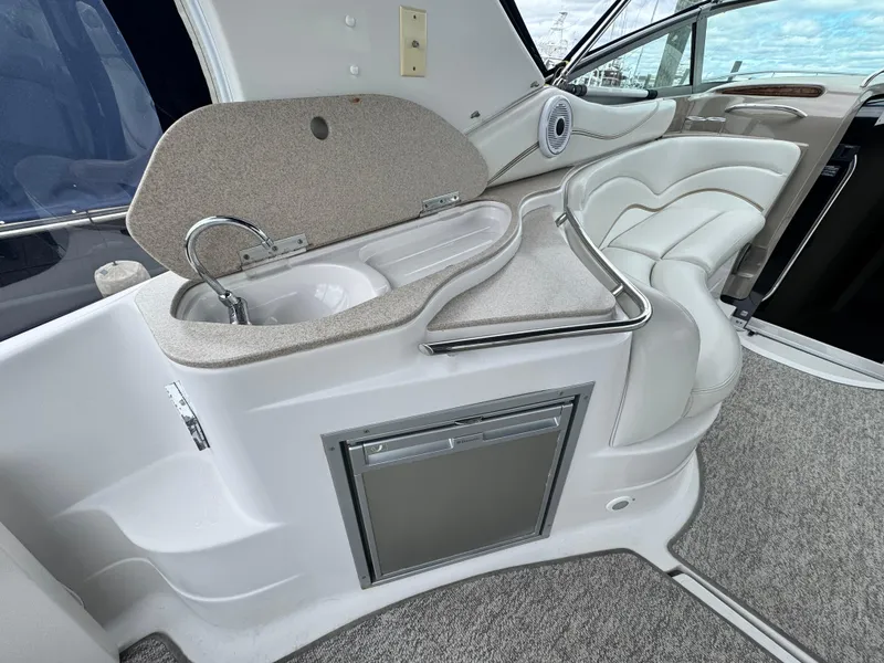 Slide: The Image of 2005 Larson 370 Cabrio yacht interior with sink, seating, and storage. - 6