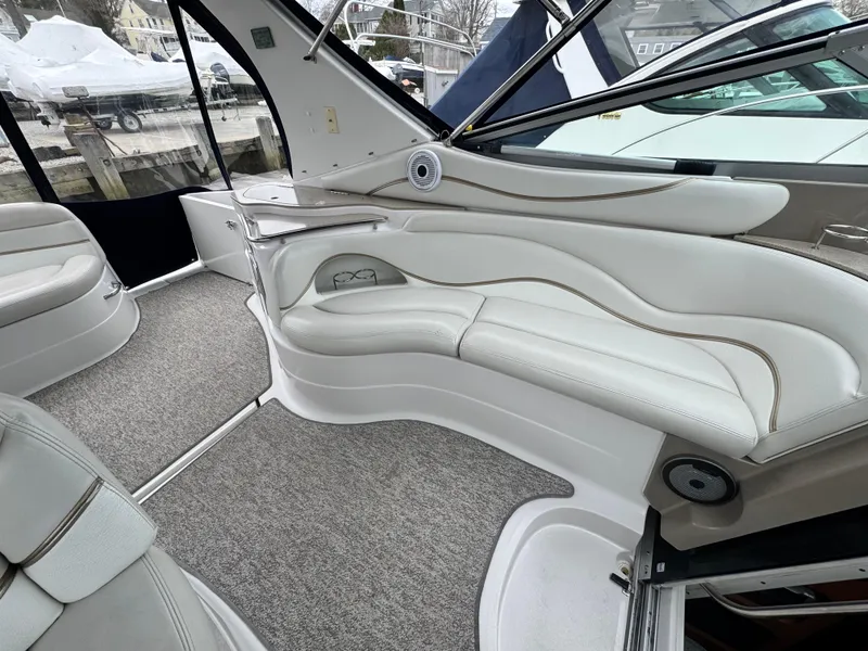 Slide: The Image of 2005 Larson 370 Cabrio boat interior with white leather seating and carpeted flooring. - 9