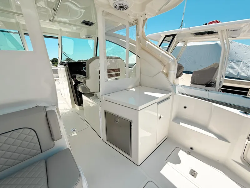 Slide: The Image of 2025 Pursuit DC 326 Dual Console interior with modern seating and sleek design. - 13
