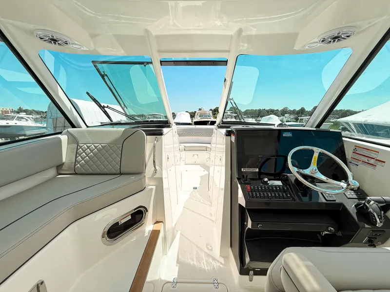 Slide: The Image of 2025 Pursuit DC 326 Dual Console interior with modern helm and seating. - 17