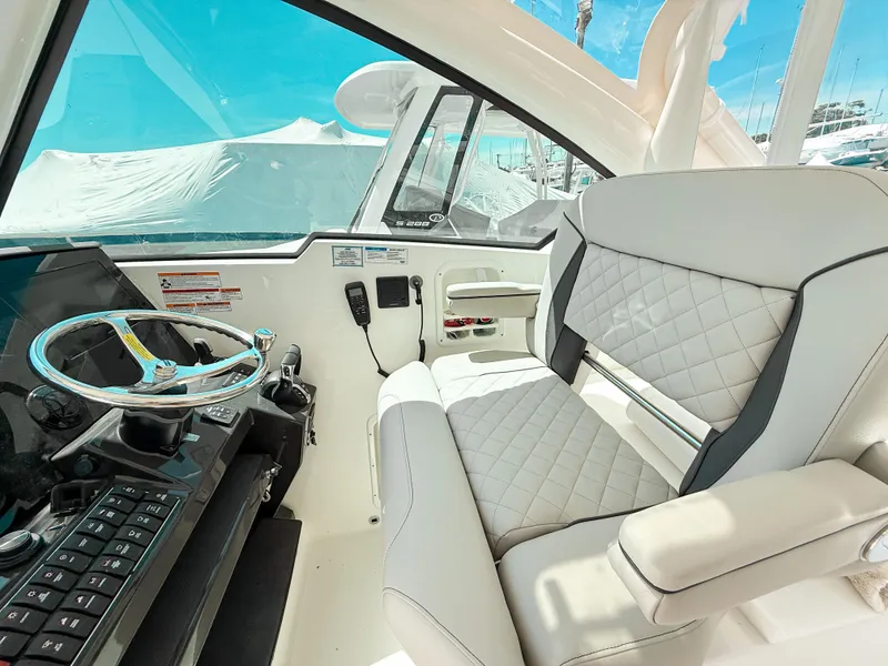 Slide: The Image of 2025 Pursuit DC 326 Dual Console interior with modern helm and luxurious seating. - 18