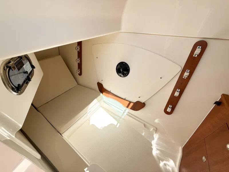 Slide: The Image of 2025 Pursuit DC 326 Dual Console cabin interior with modern design and wood accents. - 22