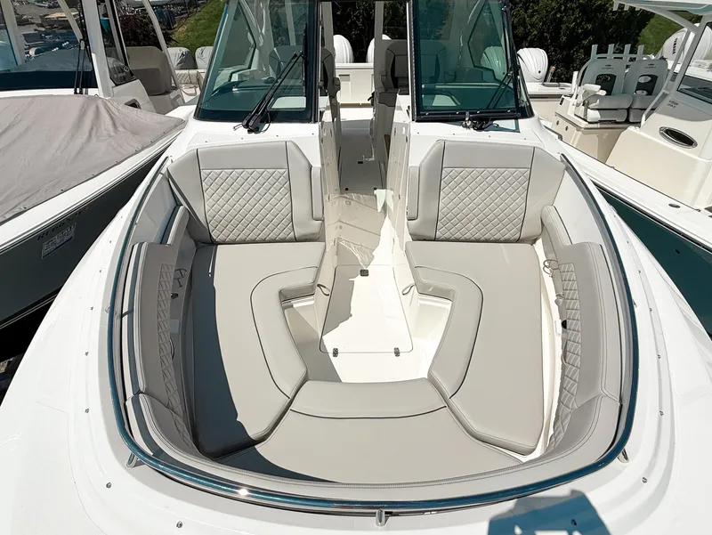 Slide: The Image of 2025 Pursuit DC 326 Dual Console boat with spacious seating and modern design. - 26