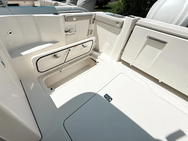 Slide: The Image of 2025 Pursuit DC 326 Dual Console boat interior with storage compartments. - 32