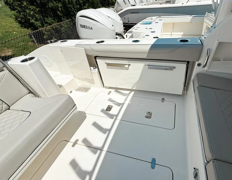 Slide: The Image of 2025 Pursuit DC 326 Dual Console boat interior with Yamaha engines, featuring spacious seating and storage. - 5