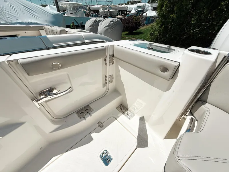 Slide: The Image of 2025 Pursuit DC 326 Dual Console boat interior with sleek white seating and modern design. - 8