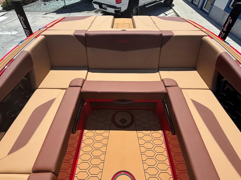 Slide: The Image of 2025 MasterCraft NXT24 boat interior with tan and brown seating, hexagonal floor pattern. - 12