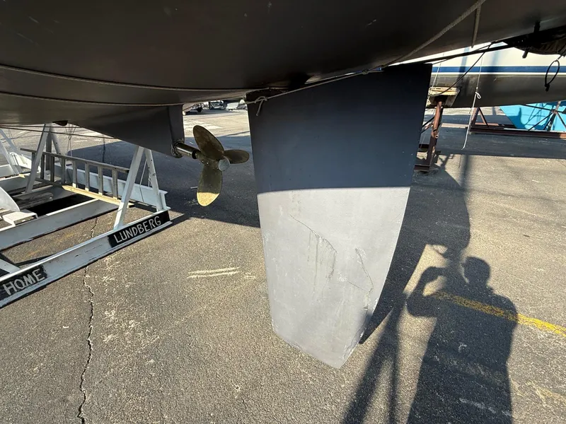 Slide: The Image of Beneteau 331 sailboat keel and propeller, 2002 model, on dry dock with shadow visible. - 16