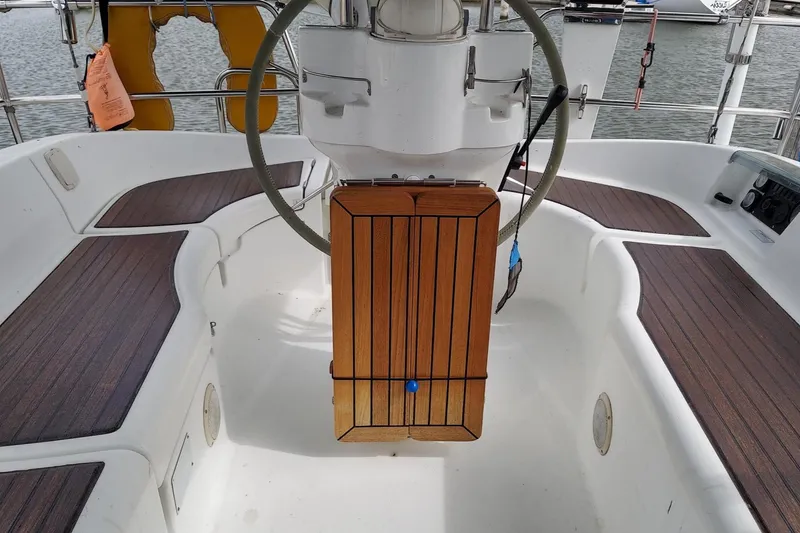 Slide: The Image of Cockpit of 2002 Beneteau 331 sailboat with wooden table and steering wheel. - 23