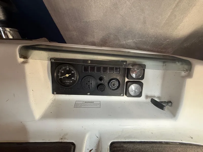 Slide: The Image of Control panel of a 2002 Beneteau 331 sailboat, featuring gauges and switches. - 28