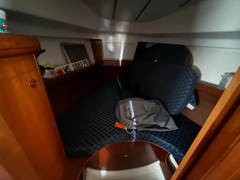 Slide: The Image of Cozy cabin interior of a 2002 Beneteau 331 sailboat with wooden furnishings. - 32