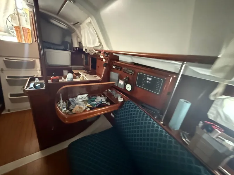 Slide: The Image of Interior of a 2002 Beneteau 331 sailboat with navigation equipment and seating area. - 34