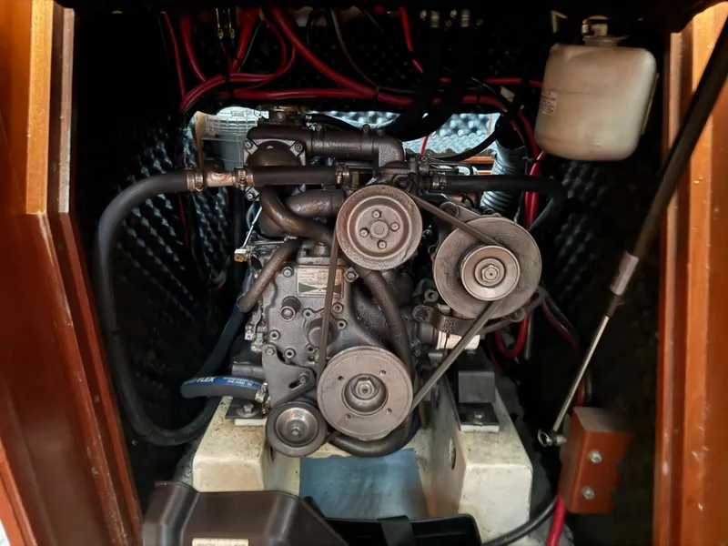 Slide: The Image of Engine compartment of a 2002 Beneteau 331 sailboat, showcasing mechanical components and wiring. - 42