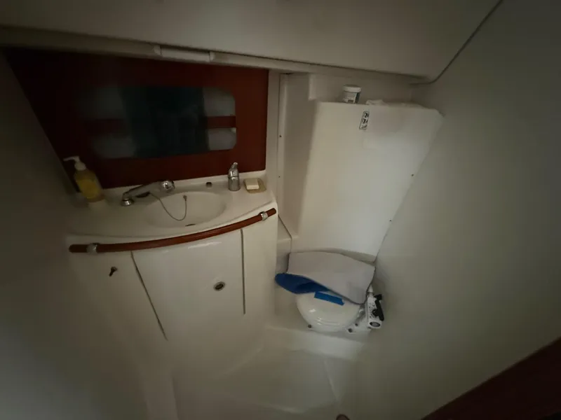 Slide: The Image of 2002 Beneteau 331 yacht bathroom with sink, mirror, and toilet. - 65