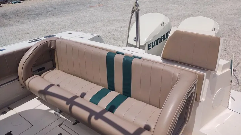 Slide: The Image of 2005 Intrepid 310 Walkaround boat seating with Evinrude engines in the background. - 3